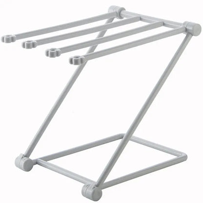 Foldable plastic dishcloth shelf organiser in Nordic style mounted on a kitchen wall