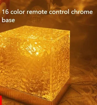 LED water ripple projection night light with remote control on wooden base showing colourful light patterns