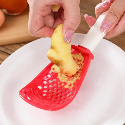 Red plastic multifunctional cooking spoon with serrated edge for grinding and half-enclosed scoop design