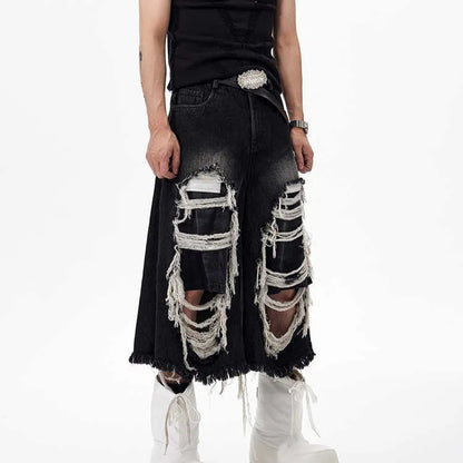 Black cropped wide-leg jeans with a mid-high waist, ripped patch detail, and a loose fit on a model.