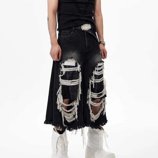Black cropped wide-leg jeans with a mid-high waist, ripped patch detail, and a loose fit on a model.
