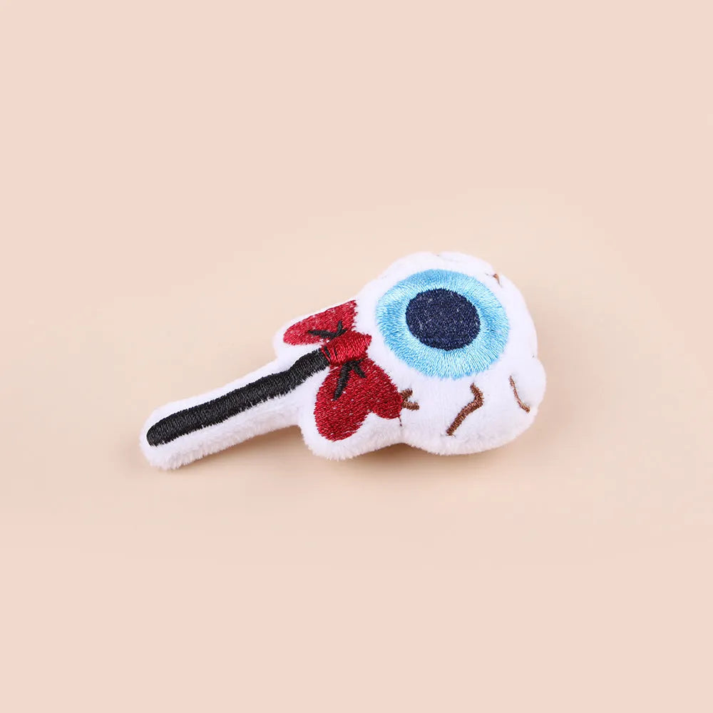 Plush cat teaser wand with candy, eyes, and skull heads on a 40cm string next to a wand handle.