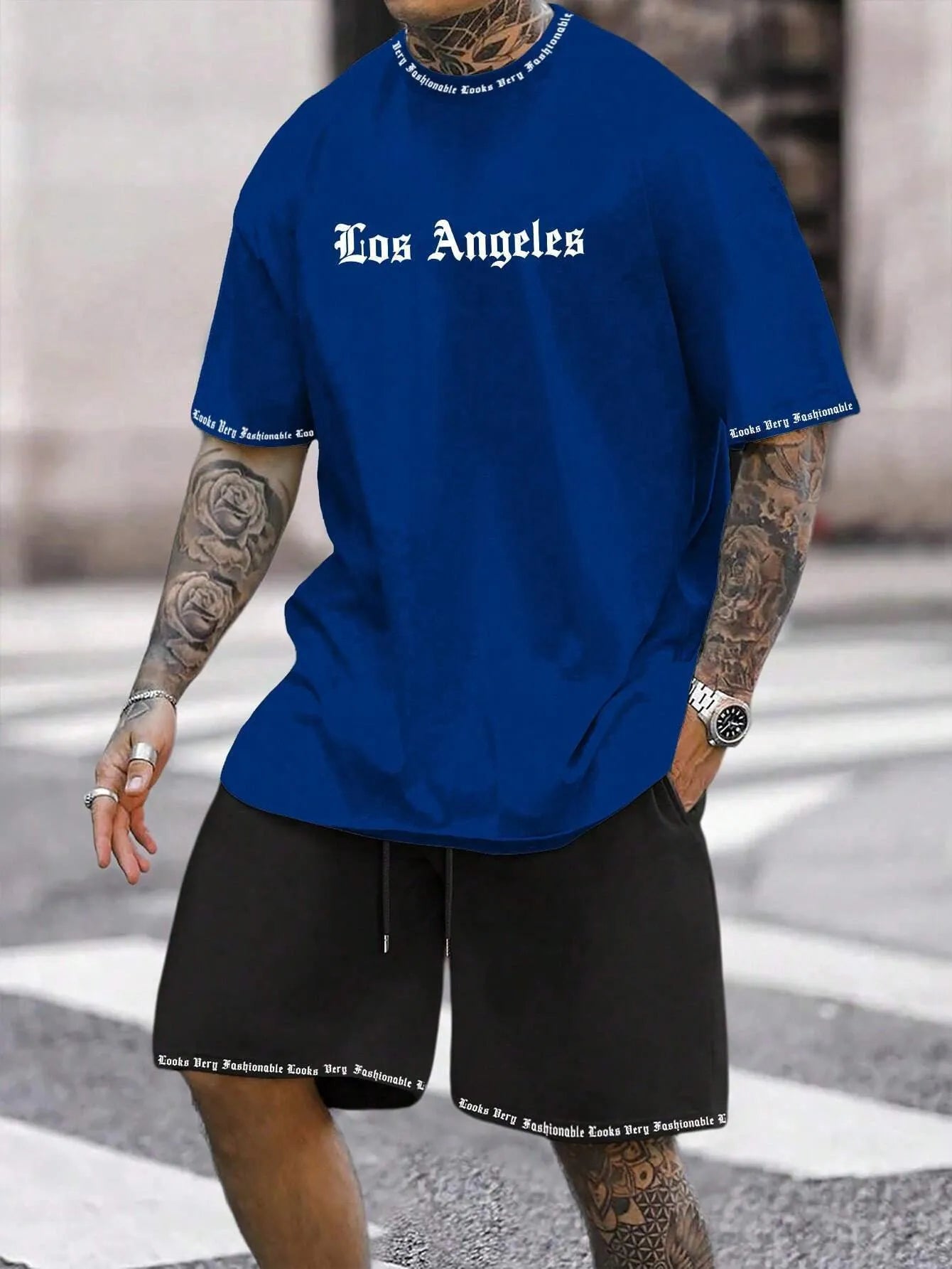 Man wearing a printed short-sleeve top and matching shorts from the sports style two-piece set.