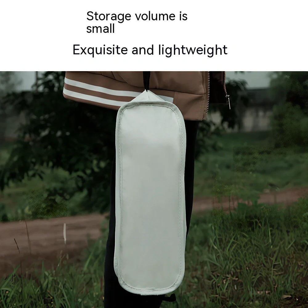 Outdoor folding chair with 600D Oxford cloth in ivory white, shown in folded position with storage bag