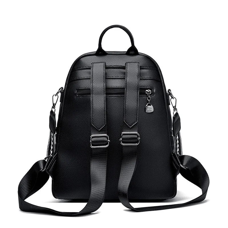 Genuine leather multi-functional commuting backpack with flap pocket, polyester lining, and metal letter patchwork details in black.