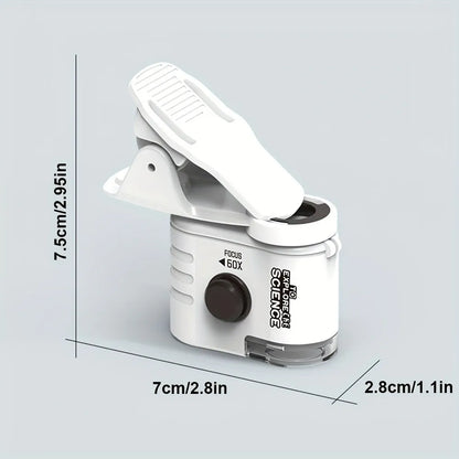 White mini mobile phone microscope with LED light and detachable clip-on adapter next to a smartphone.