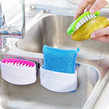 Blue kitchen brush with utensil slots and suction cup for fruit and vegetable cleaning