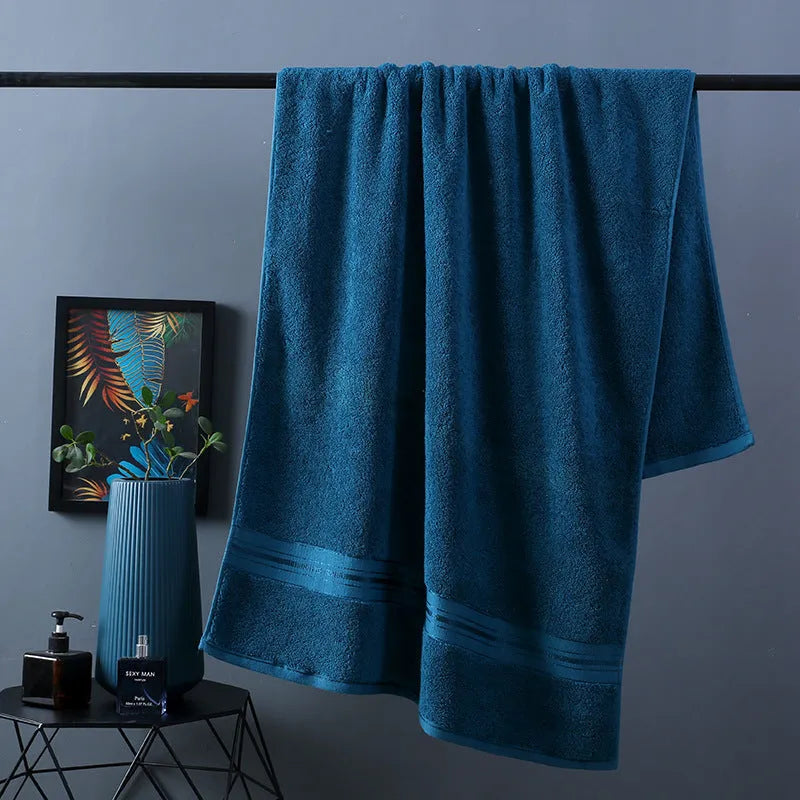 Three-piece cotton towel set showing bath towel, towel, and square scarf in coordinating colours