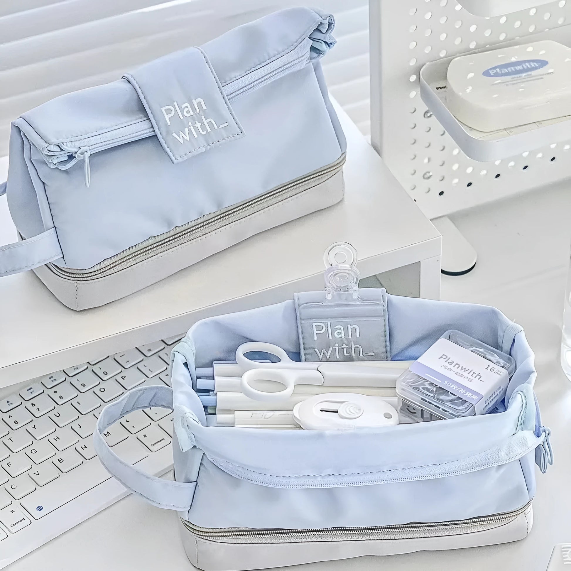 Double-layer folding pencil case showing navy blue colour with pens organised in separate compartments
