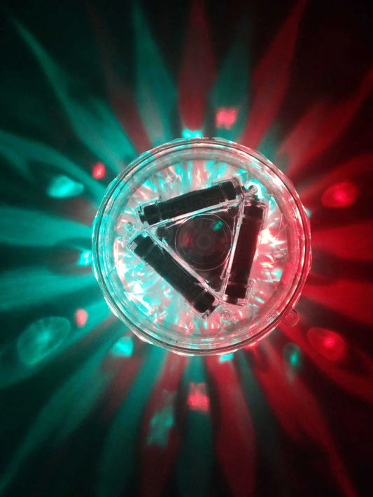 Round water lamp with changing colours submerged in bath, showing blue and purple LED illumination through clear polycarbonate shell