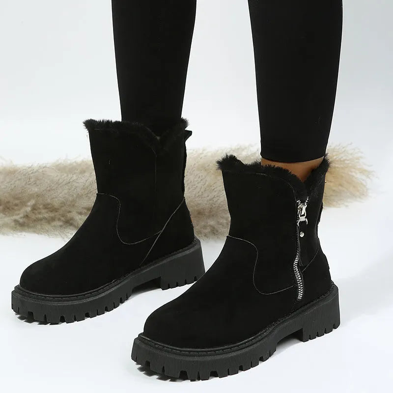 Women's black high top snow boots with a faux suede upper and side zipper on a white background.