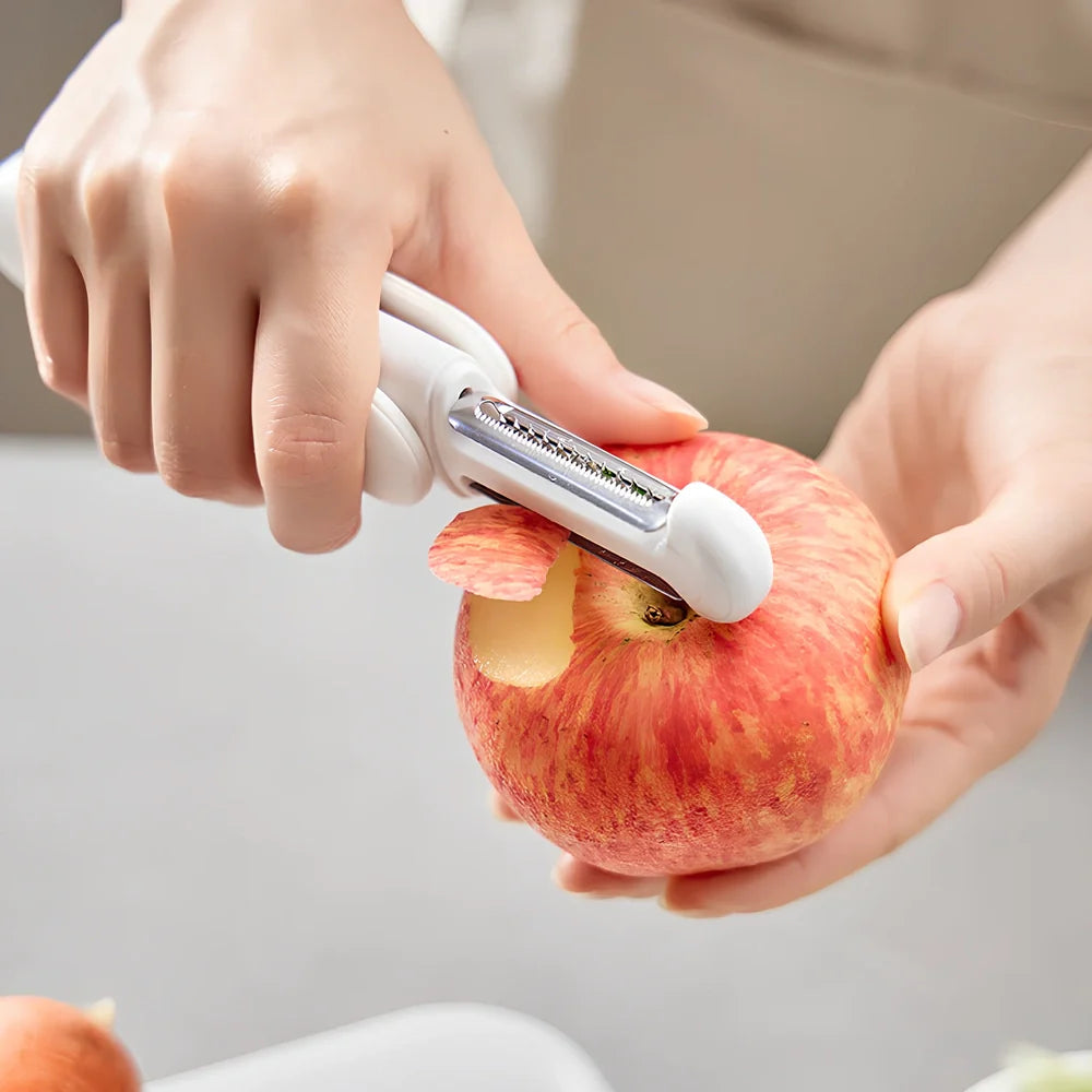 White 3-in-1 rotary paring knife with stainless steel blades showing 360° rotating mechanism