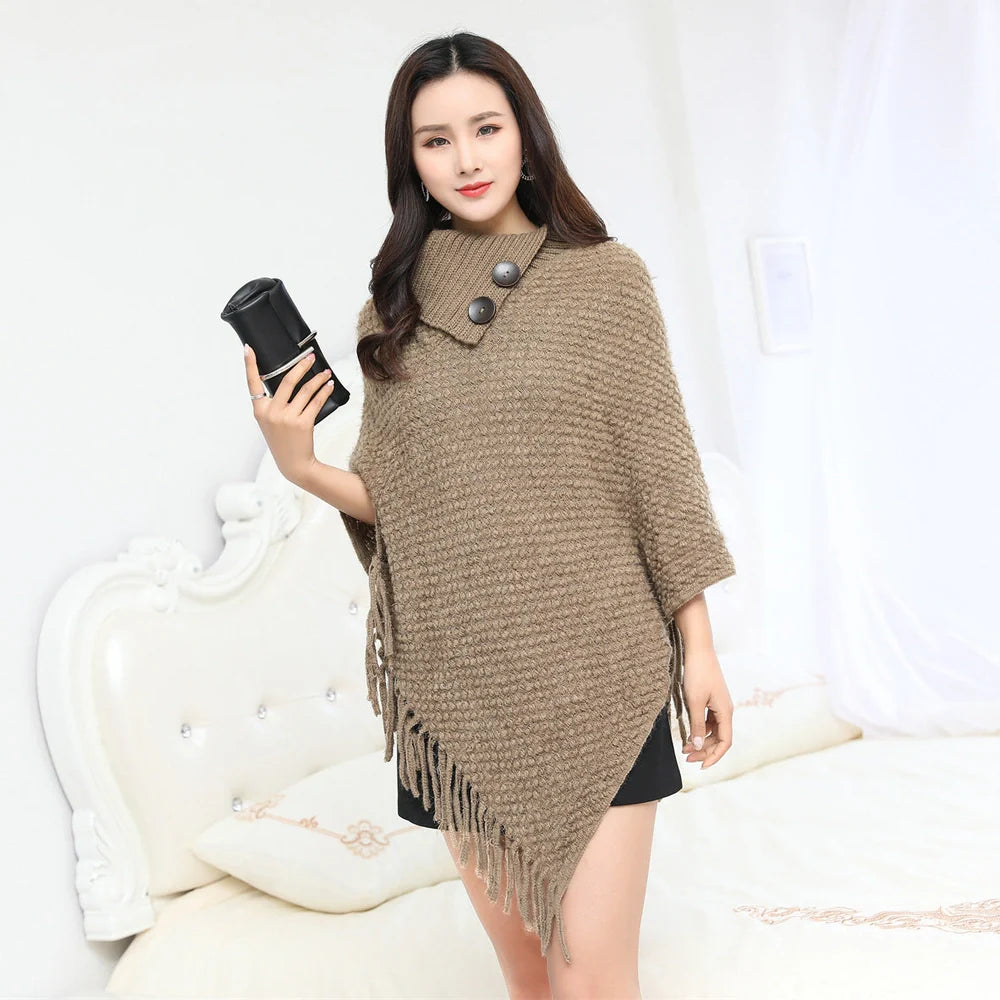 Sleeveless polka dot shawl in apricot colour draped over chair, showing 150cm length and acrylic fibre texture