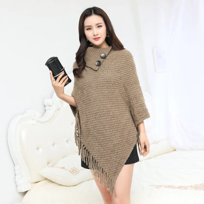 Sleeveless polka dot shawl in apricot colour draped over chair, showing 150cm length and acrylic fibre texture