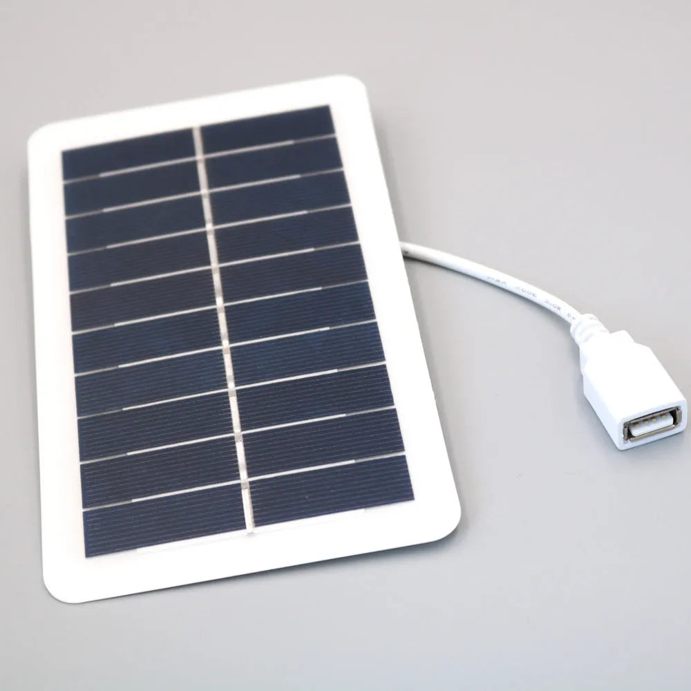 Black solar panel mobile phone charger with USB port showing compact portable design
