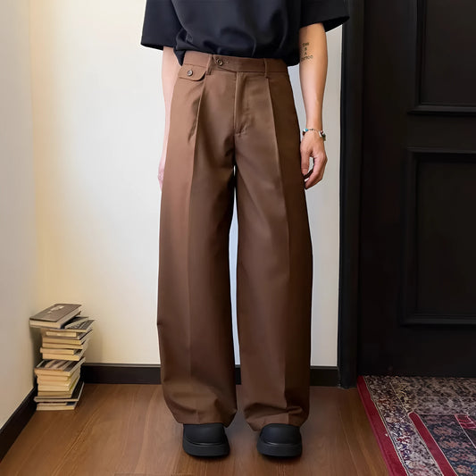 Man wearing brown straight-leg loose drape casual trousers with a relaxed fit.