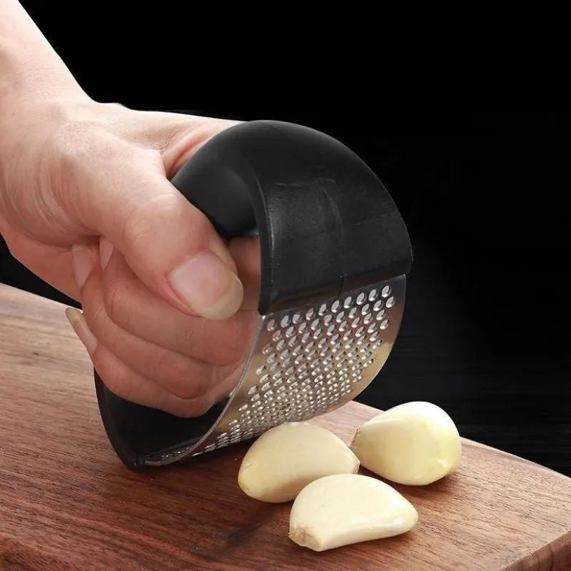 Stainless steel garlic press with ergonomic handle in kitchen setting