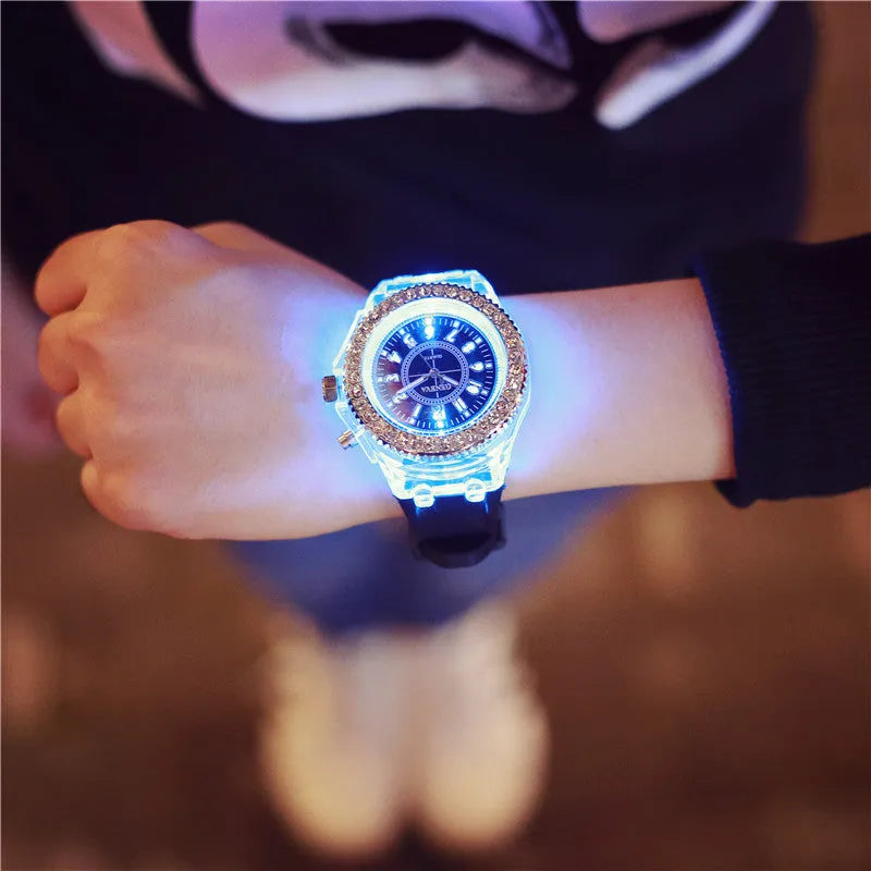 Women's LED luminous quartz watch with silicone strap and round alloy case on wrist