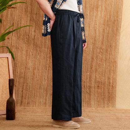 Linen high-waisted trousers with an elasticated waistband and loose straight-leg cut in greige colour