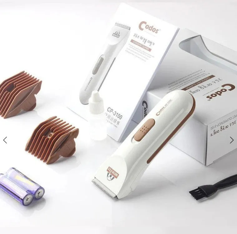 White electric pet hair clipper with ceramic blade showing battery compartment