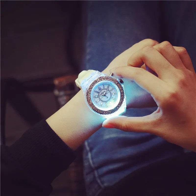 LED luminous women's quartz watch with silicone bracelet, featuring alloy case, round dial with plexiglass mirror, pointer and number display, onion head crown, pin buckle clasp, and 43mm diameter in 11 colour options including black, blue, and pink