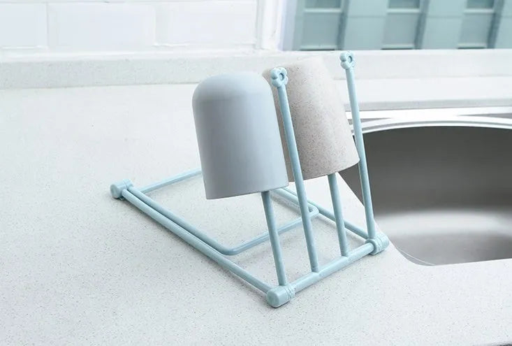 Foldable plastic dishcloth shelf organiser in Nordic style mounted on a kitchen wall
