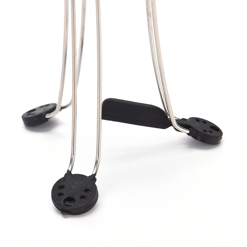 White and black wireless automatic kitchen stirrer with three-speed button, shown next to a saucepan.
