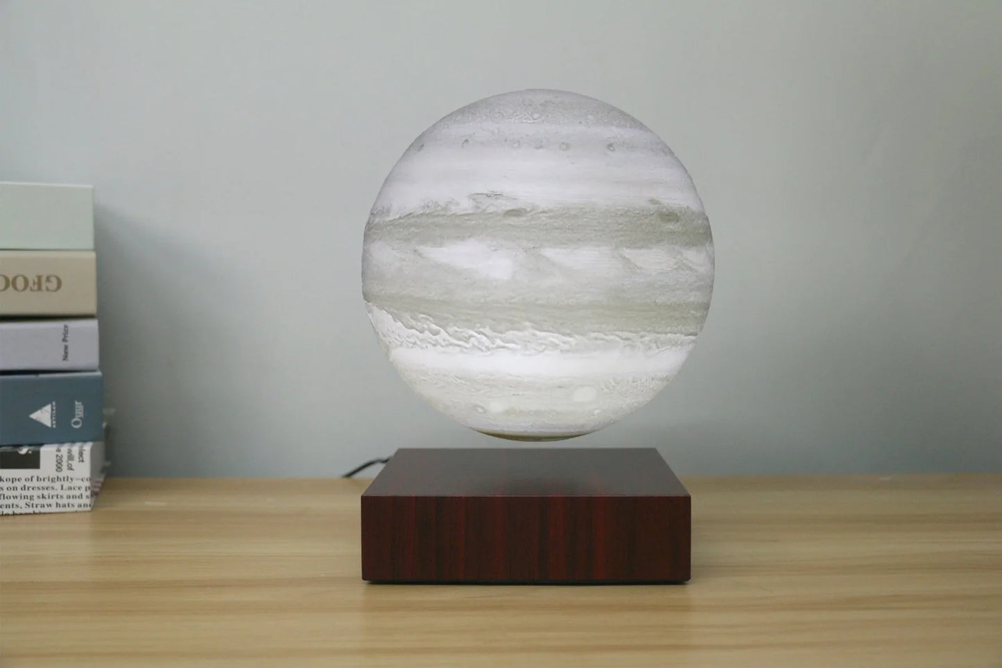 Levitating Earth or Jupiter lamp floating above base with LED illumination