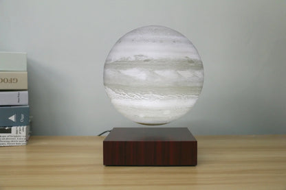 Levitating Earth or Jupiter lamp floating above base with LED illumination
