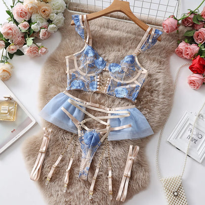 Light blue embroidered lace bra and knicker set with transparent mesh panels on a mannequin.
