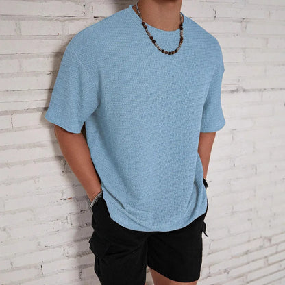 Men's slim-fit solid colour short sleeve T-shirt on a hanger, showing lightweight fabric.