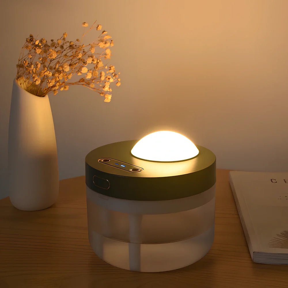 White portable humidifier with rotating projection light showing blue illumination and dual spray mist output