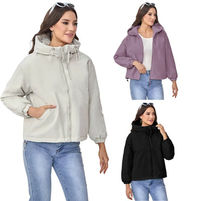 Women's grey hooded shell jacket with loose fit and long sleeves on hanger