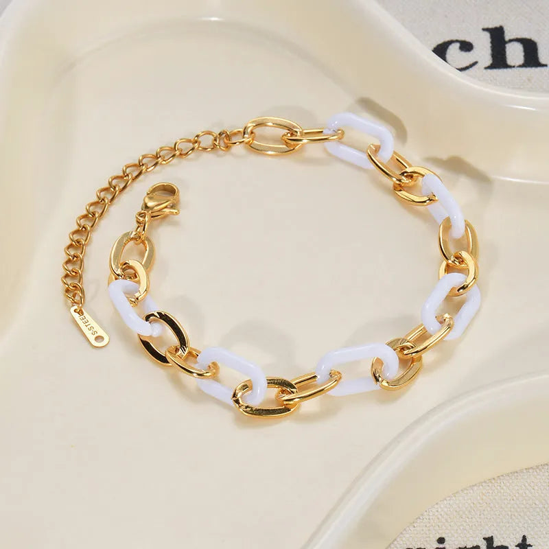 Stainless steel bracelet with double-layer heart design containing resin elements, shown on wrist