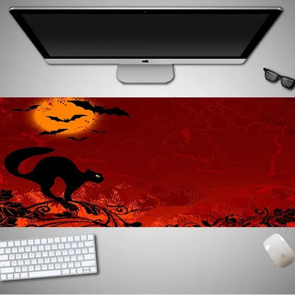 Oversized black Halloween-themed mouse pad with graphic design on a desk with keyboard and mouse