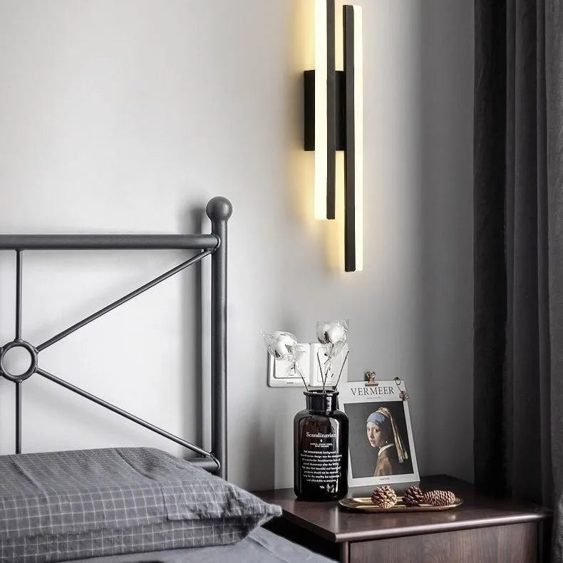 Scandinavian minimalist LED wall light with acrylic shade and adjustable arm in black or gold finish.