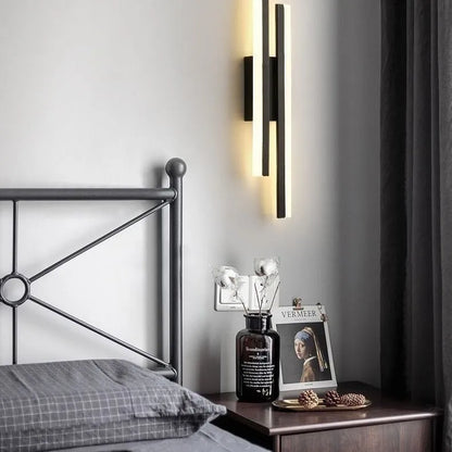 Scandinavian minimalist LED wall light with acrylic shade and adjustable arm in black or gold finish.