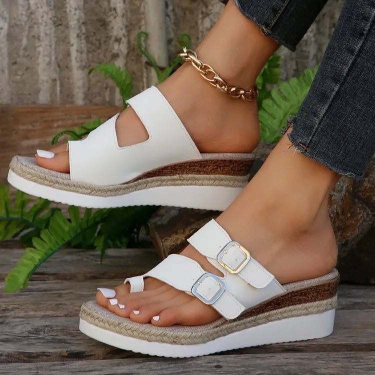 White patent leather wedge sandals with peep toe and finger fit design