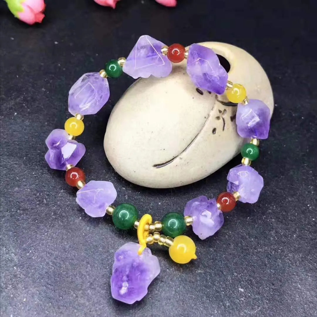 Natural shaped purple amethyst bracelet for women with a fu character bead on a white background.
