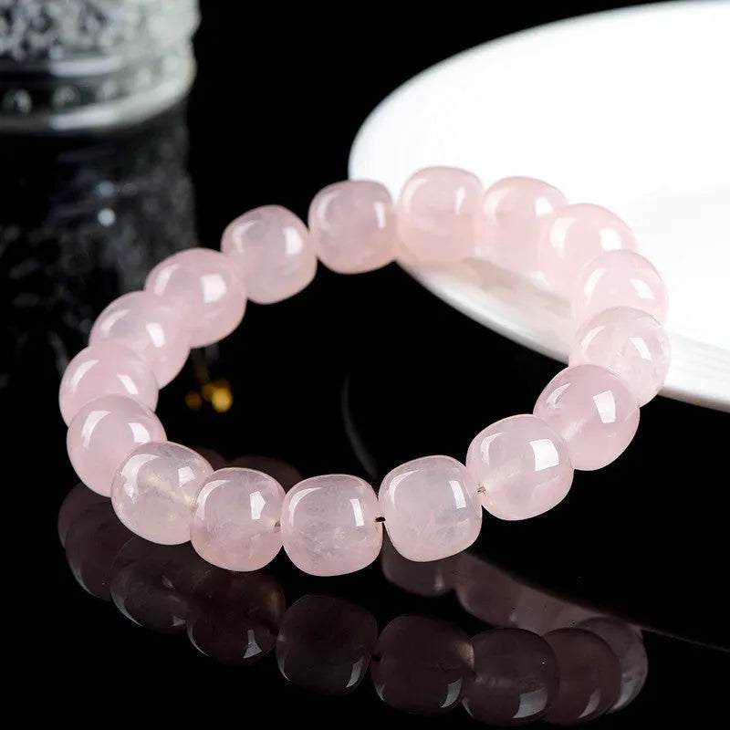 Pink crystal barrel bead bracelet with geometric design measuring 11-12mm beads on wrist