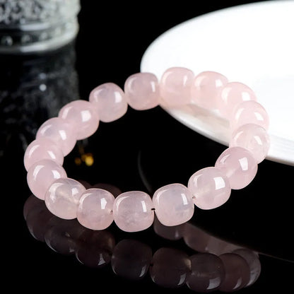 Pink crystal barrel bead bracelet with geometric design measuring 11-12mm beads on wrist
