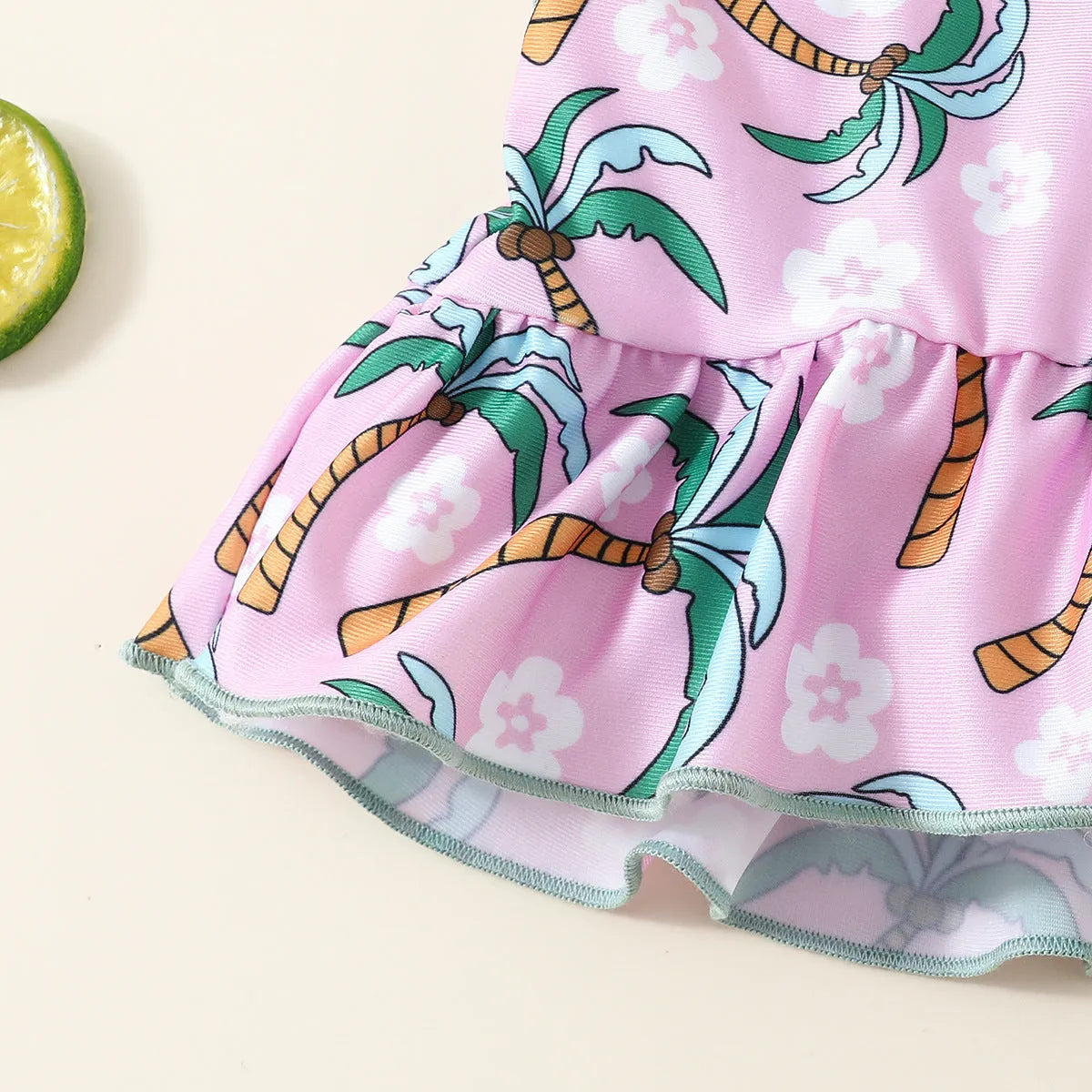 White children's two-piece polyester swimsuit set with a top and shorts on a hanger.
