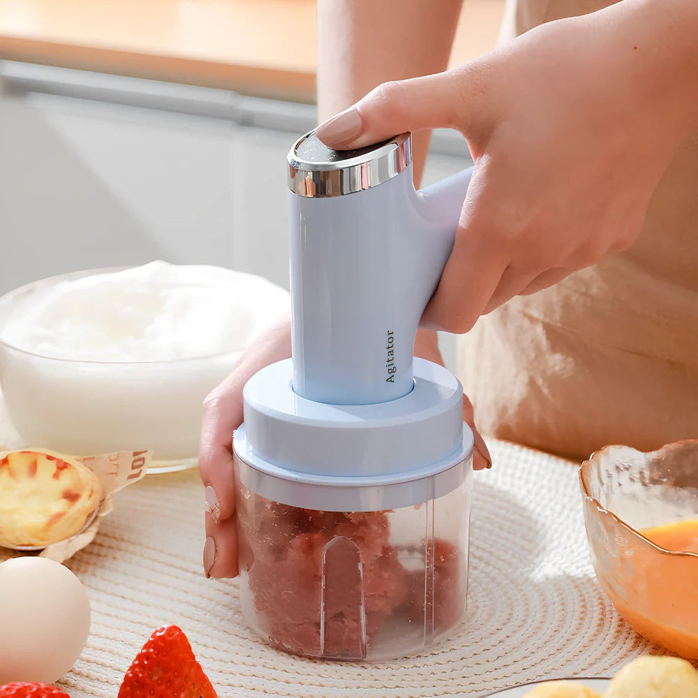 Pink electric whisk with stainless steel beaters showing 5-speed dial and compact 12cm housing