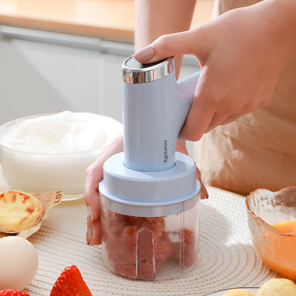 Pink electric whisk with stainless steel beaters showing 5-speed dial and compact 12cm housing