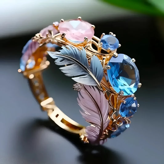 Gold colour brass feather ring with embossed geometric design and zircon inlays showing colourful pattern detail
