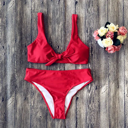 Close-fitting bikini set in a solid colour on a neutral background, showing the bra and matching briefs.