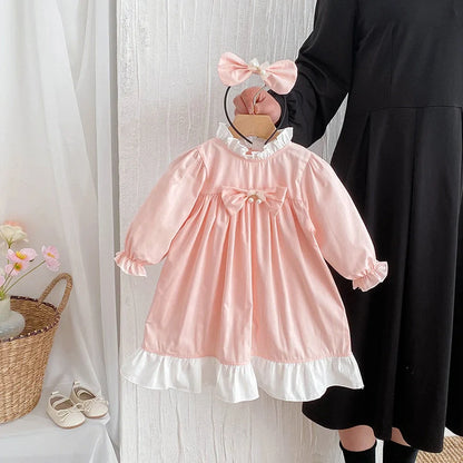 Girl wearing peach branch climbing colour triangle jumpsuit with princess dress styling and matching headband