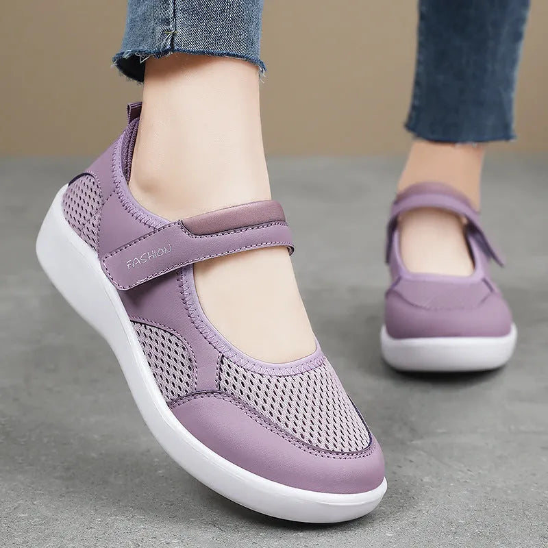 Women's grey velcro casual shoes with mesh upper and flat sole.