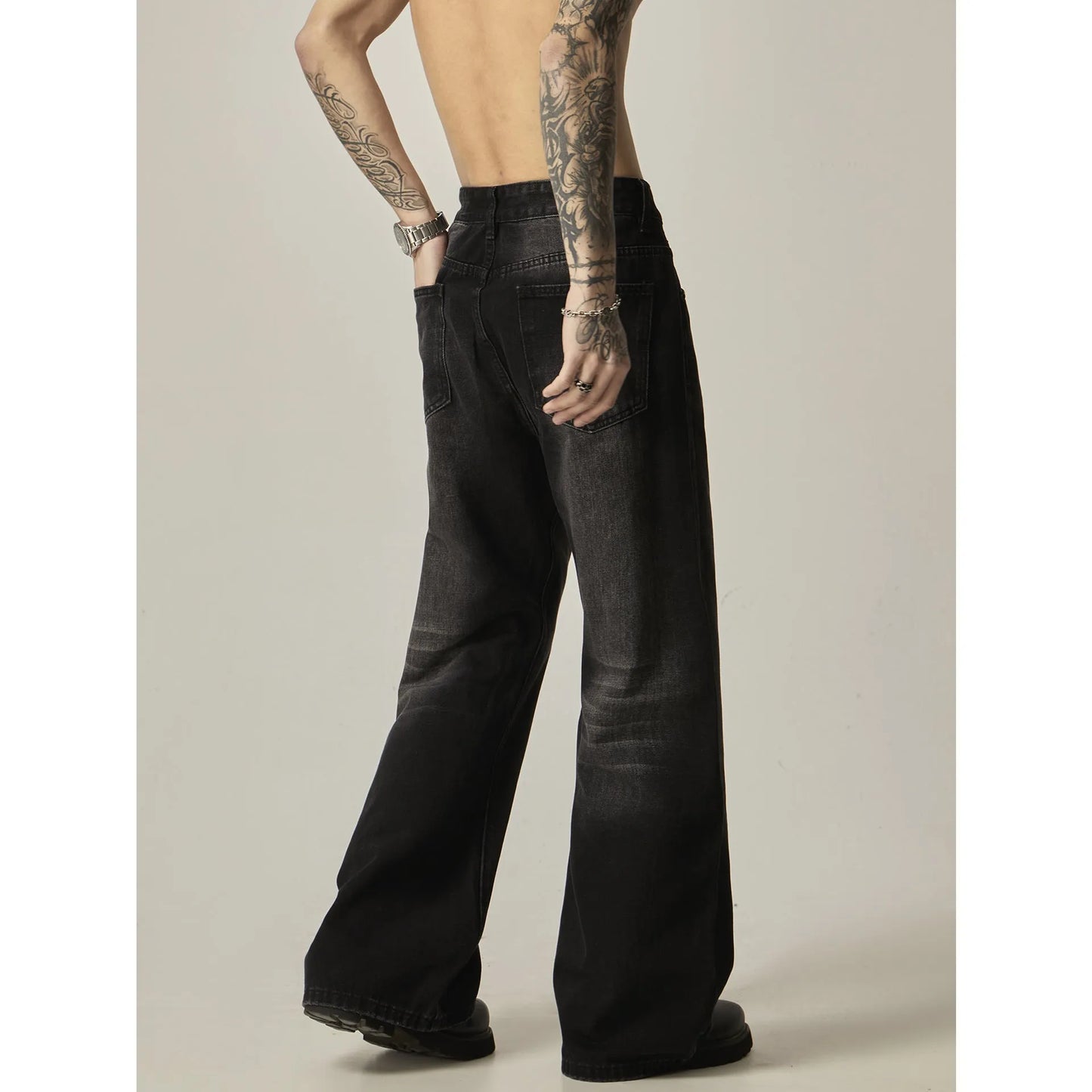 Black loose straight jeans with retro styling, zipper fly, and inelastic denim fabric