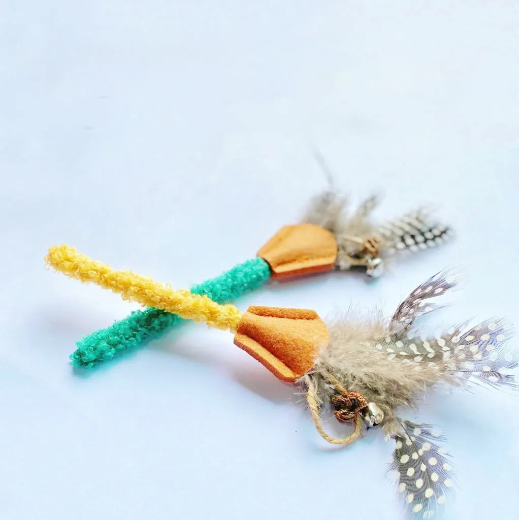 Polygonum wood cat chew toy with green and yellow feather attachments for dental health and interactive play
